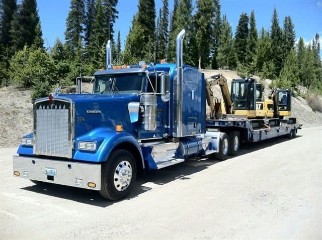 Western Towing Kenworth lowboy loaded with two excavators