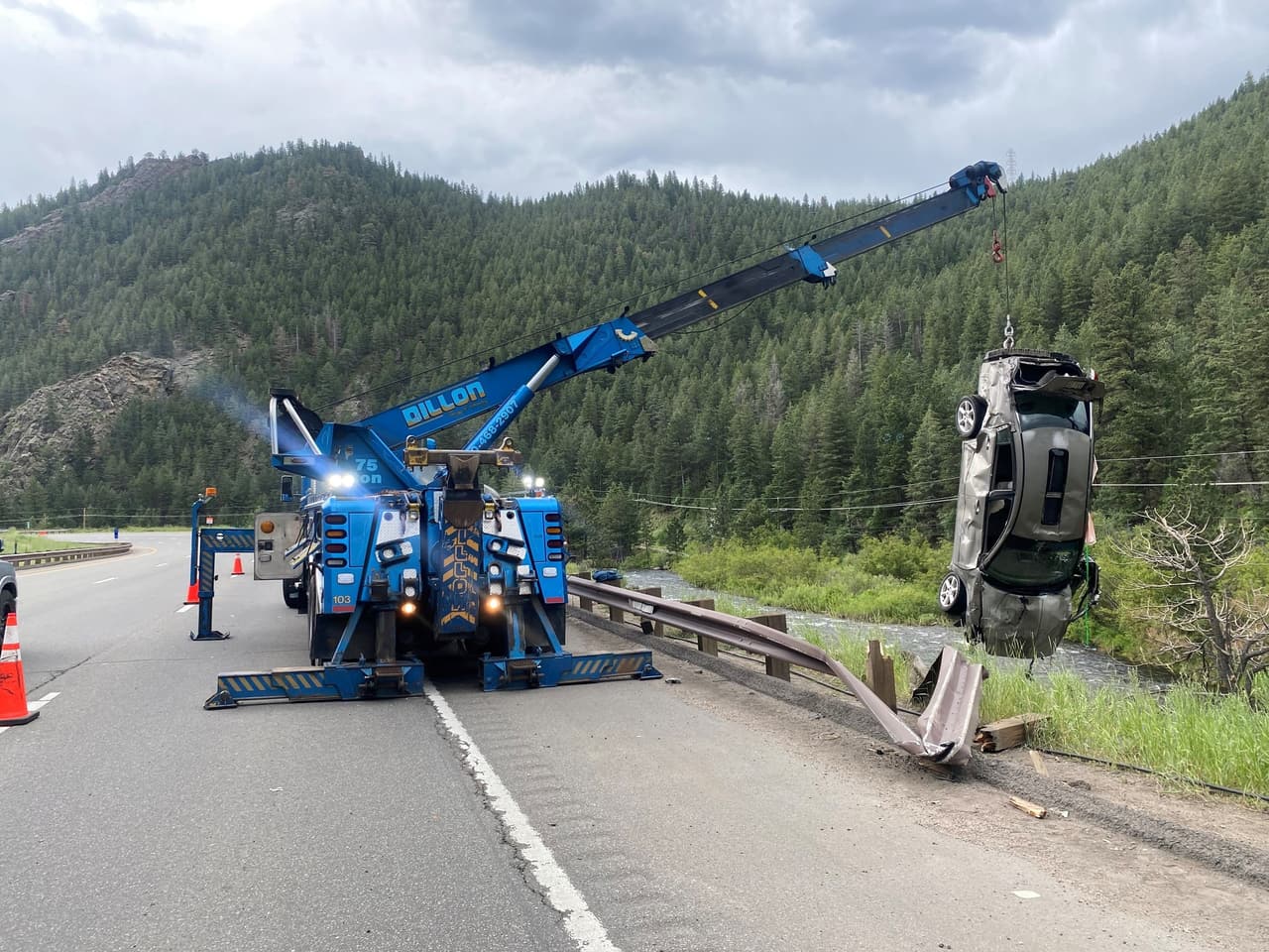 Western Towing rotator lifting a crashed car from a riverbank
