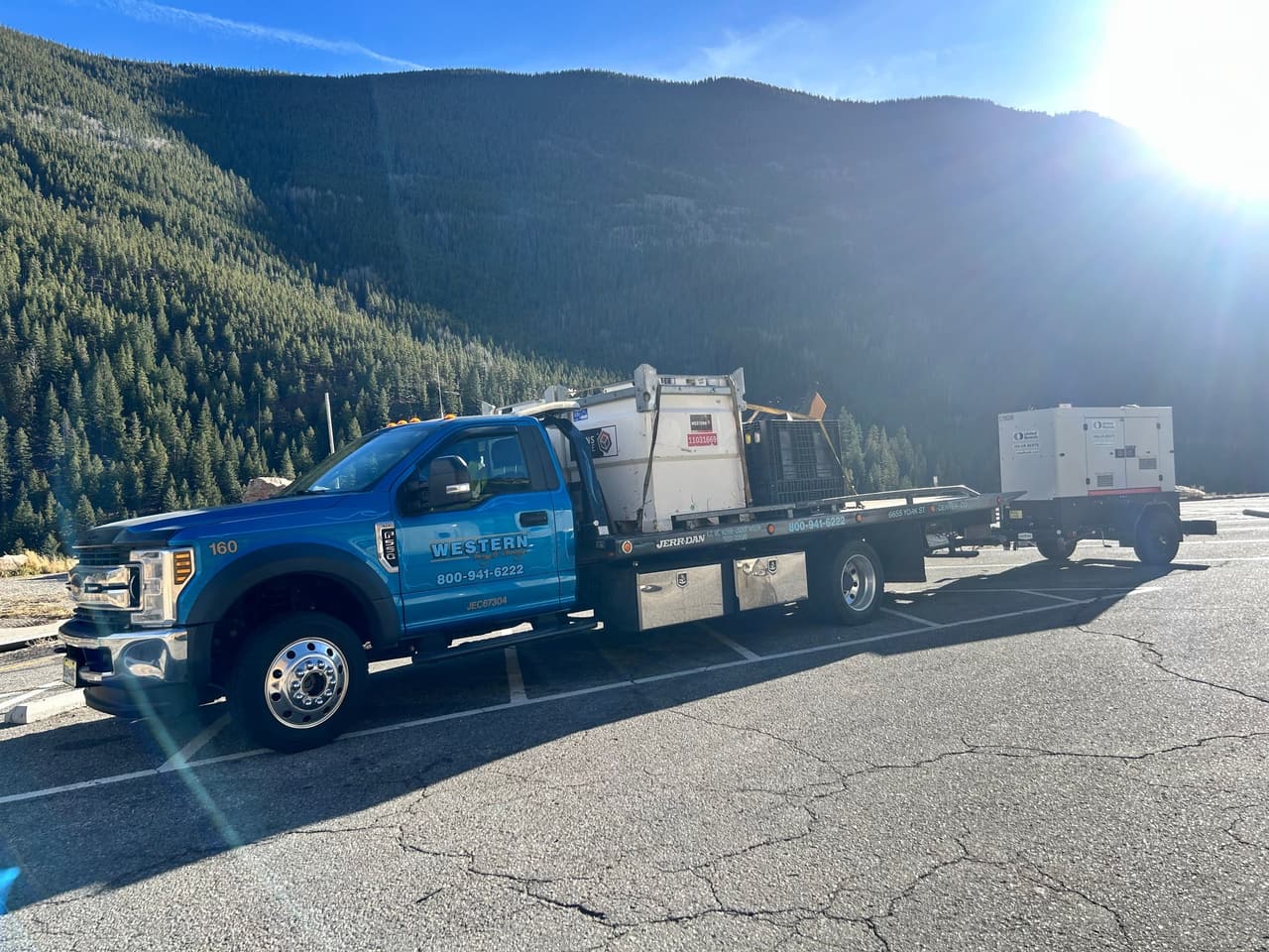 Western Towing rollback hauling generators in the mountains