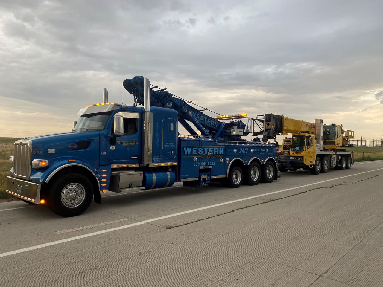 Western Towing heavy rotator towing a crane truck on a Colorado highway
