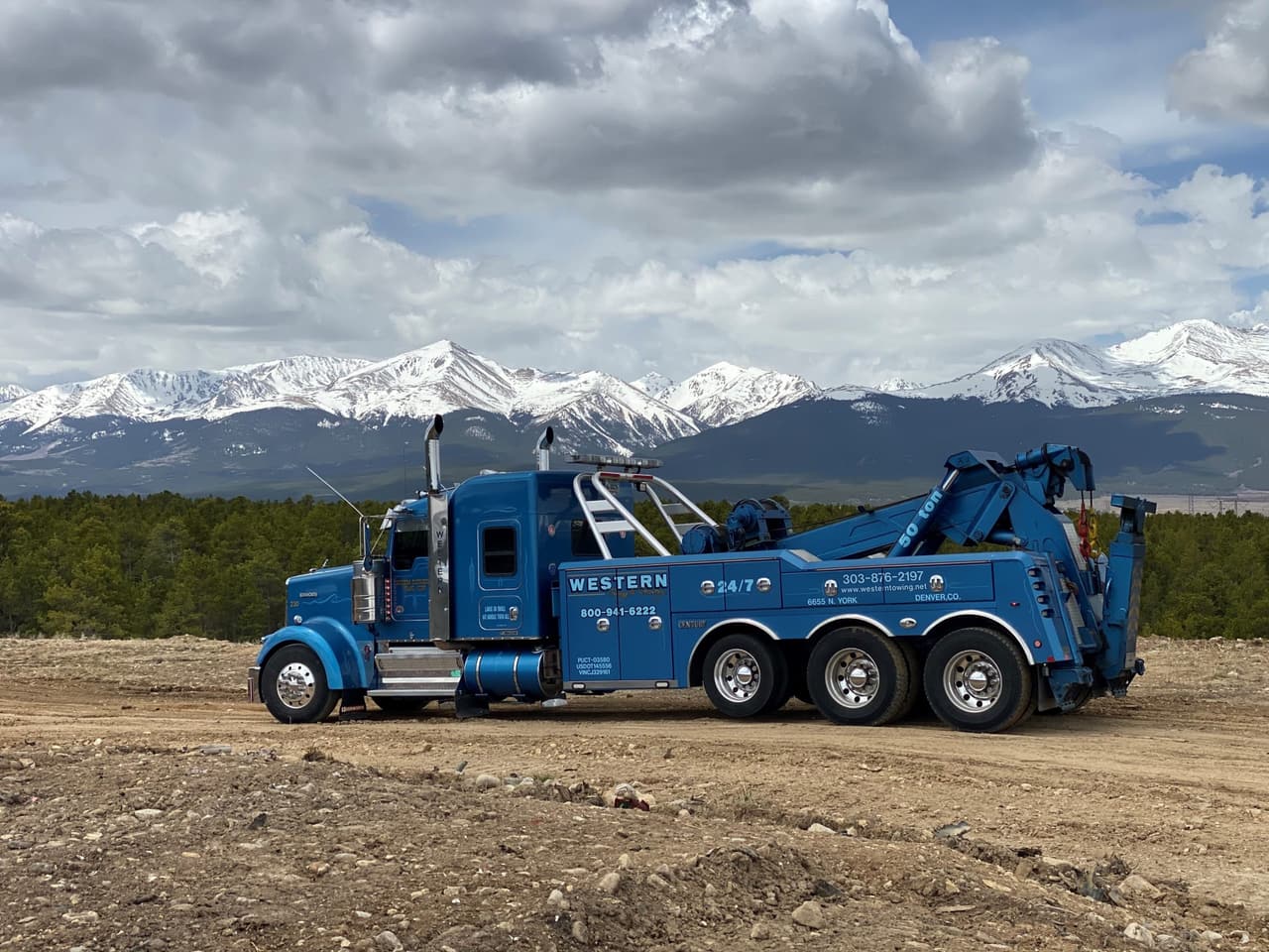 Western Towing Kenworth heavy wrecker with snow-capped mountains behind
