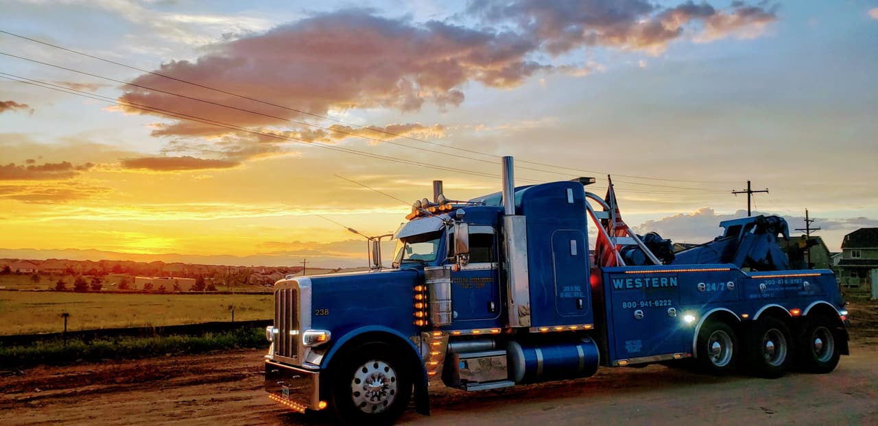 Western Towing truck lit up at dusk